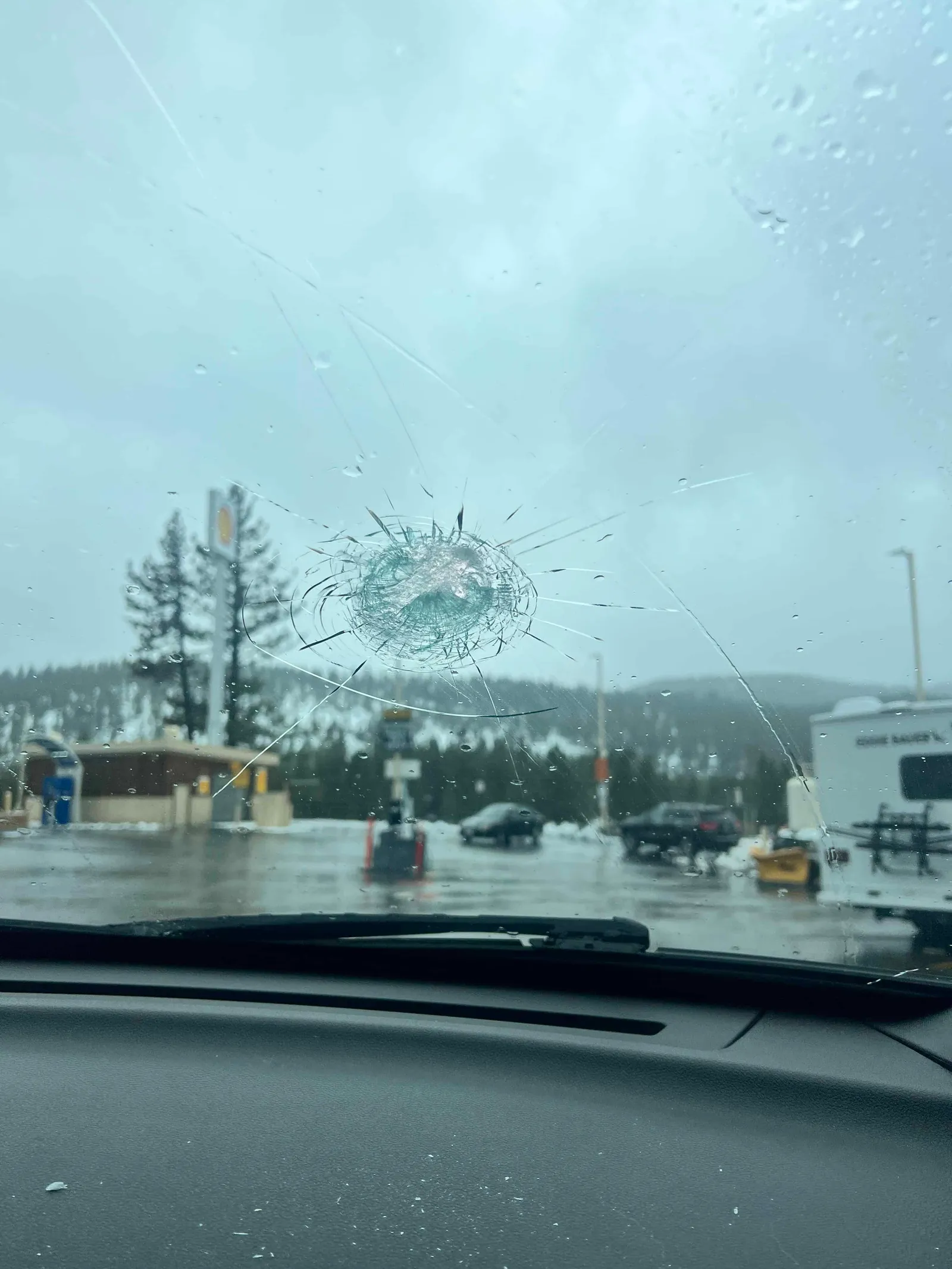 Driver's view through a cracked windshield showing visibility and safety risk