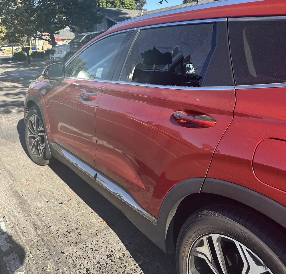 Shattered rear door window on a red 2020 Hyundai Santa Fe in Roseville, CA