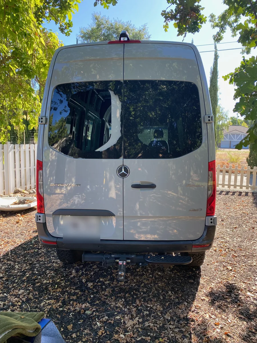 Broken back glass on a 2024 Mercedes Sprinter van before mobile replacement